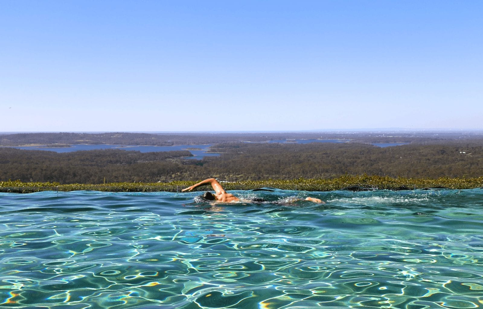 man swimming in luxury pool