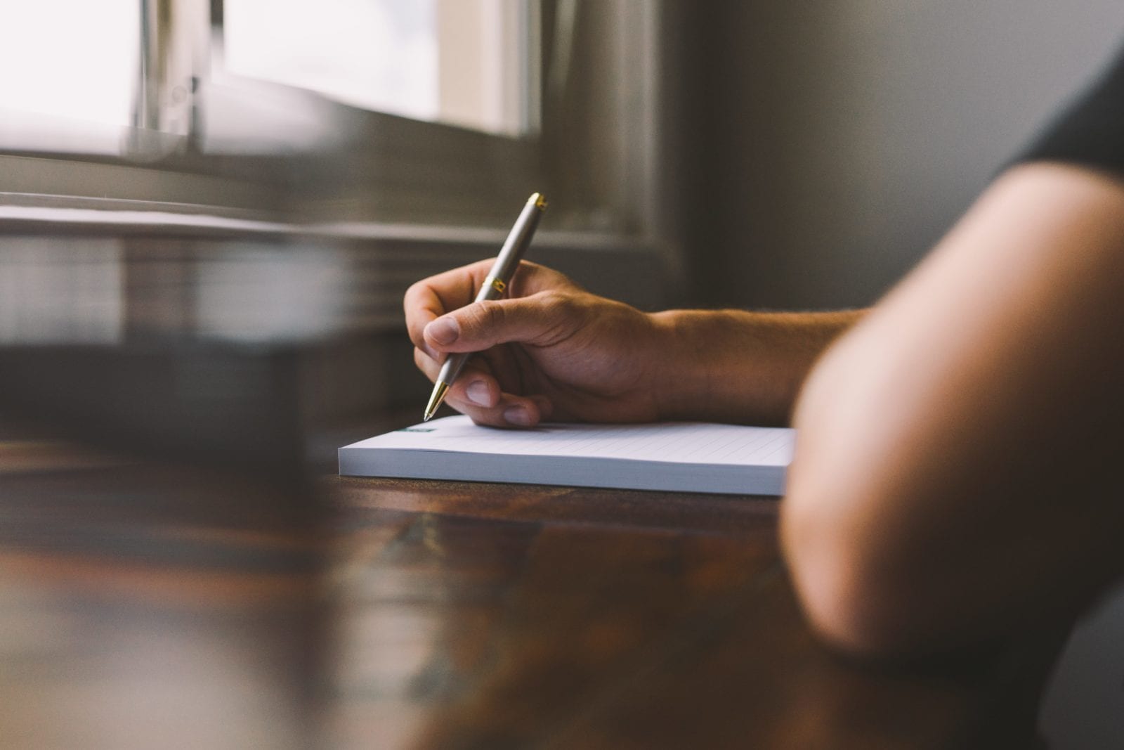 writing on notepad on desk