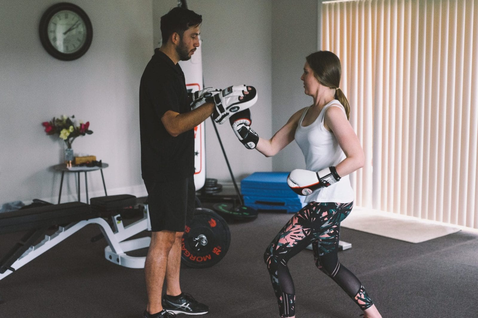Woman boxing with trainer