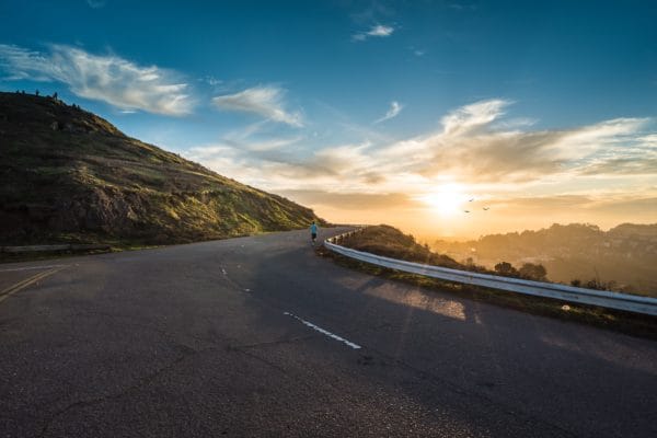 An image of the road with sunset in the background