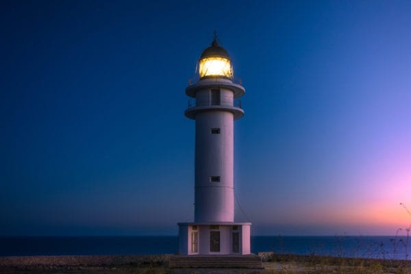 A lighthouse at sunset, depicting safety and protectoral wellness
