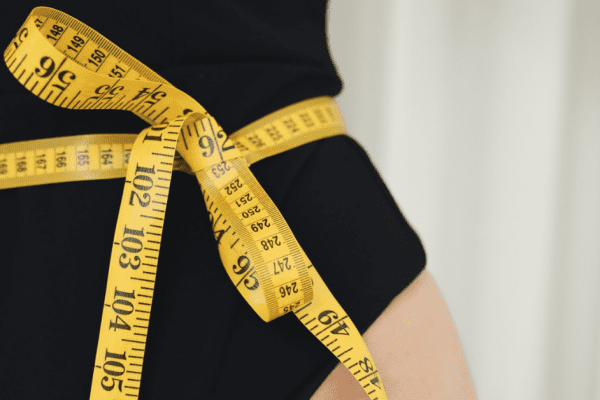 Measuring tape wrapped around a person's body part