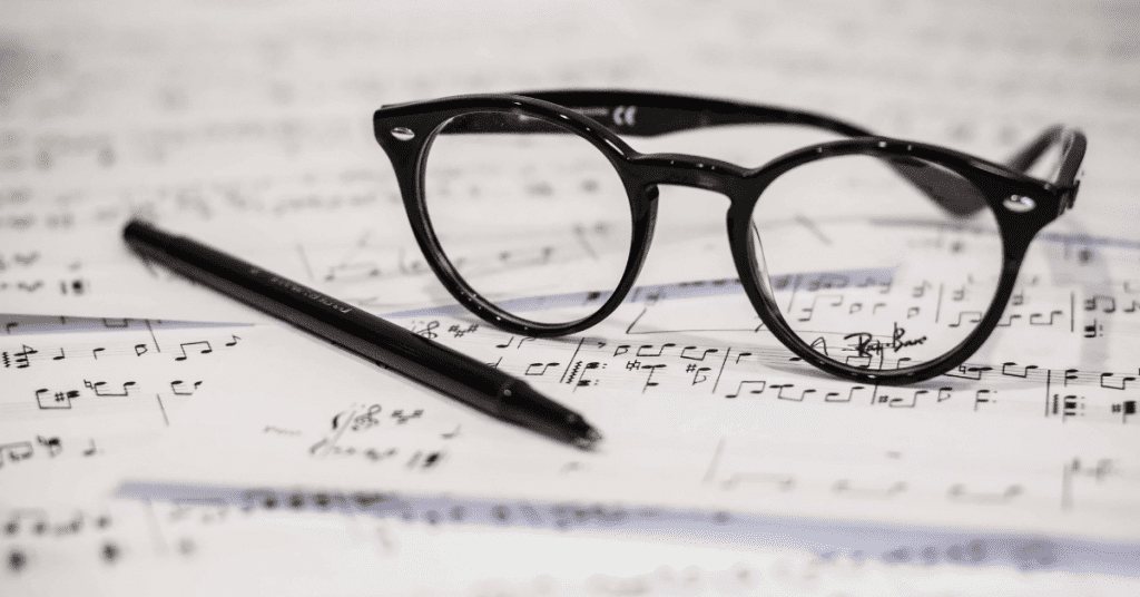 sheet music with pen and glasses