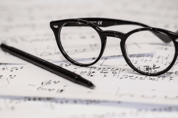 sheet music with pen and glasses