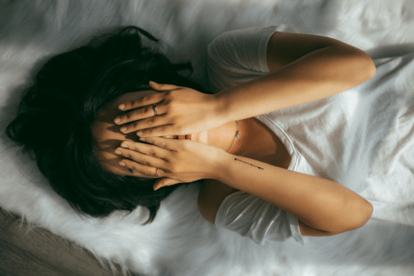 woman putting her hands over her face