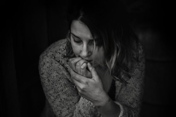 Image of an anxious woman showing signs of anxiety