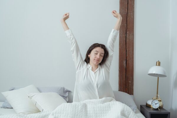 A photo of a woman in bed who has had treatment for insomnia