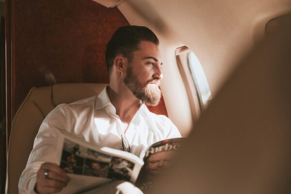Photo of a man sitting on a private jet en route to The Banyans luxury rehab