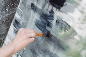 A woman painting an abstract artwork during art therapy