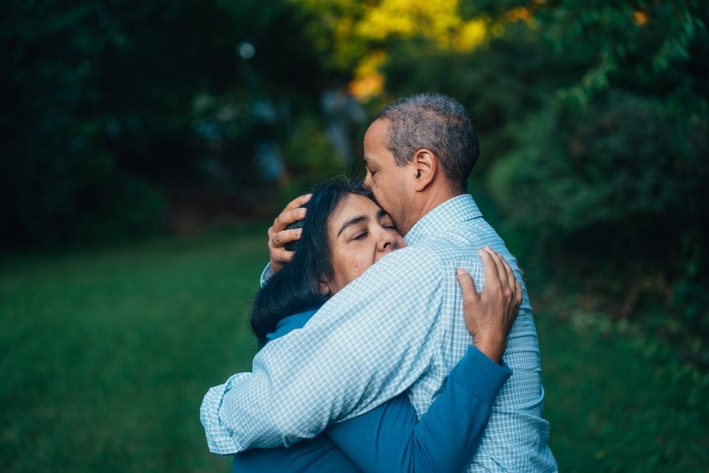 A loved one hugging their partner who is suffering from depression