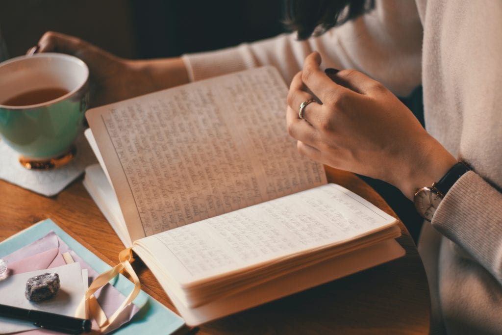 Woman journalling to relieve stress in self-isolation