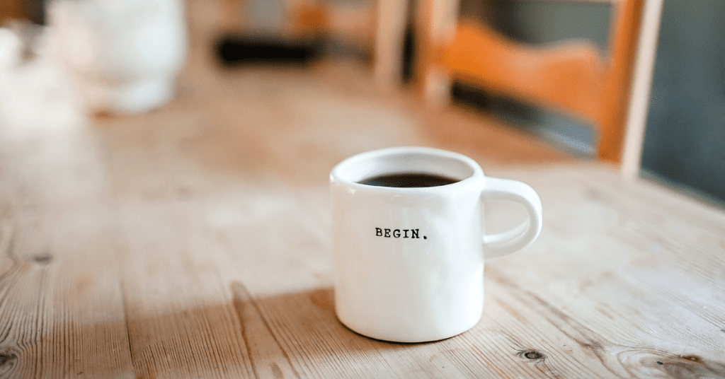 Coffee mug which says begin