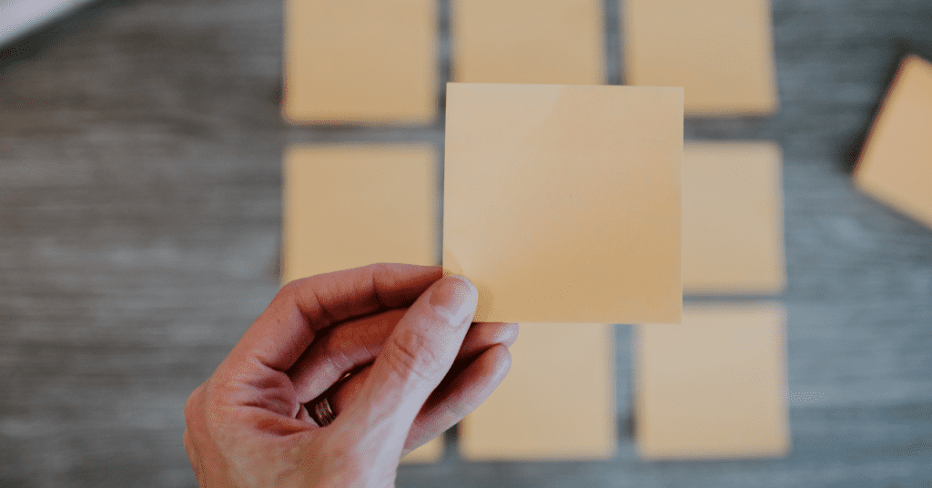 Hand holding ten Post-It notes