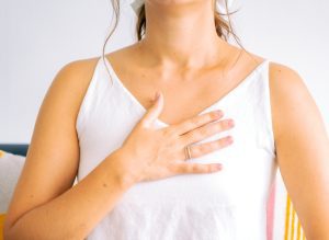 A woman showing signs of anxiety and using breathing to manage her anxiety