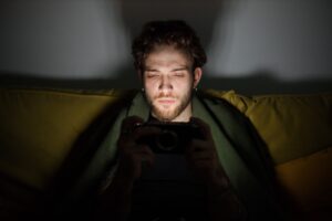 Man staying up late at night addicted to video games