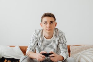Young adolescent male playing video games