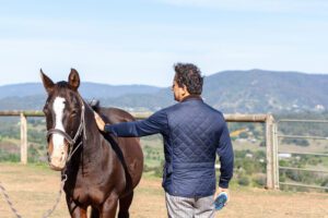 A man engaging equine therapy at The Banyans, Victoria's preferred wellness retreat