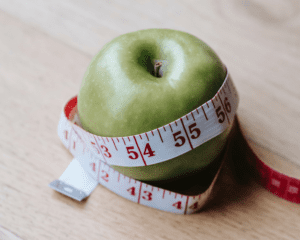 Apple with measuring tape wrapped around