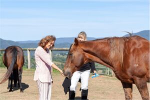 A woman engaging with horse therapy at the best rehab in Australia